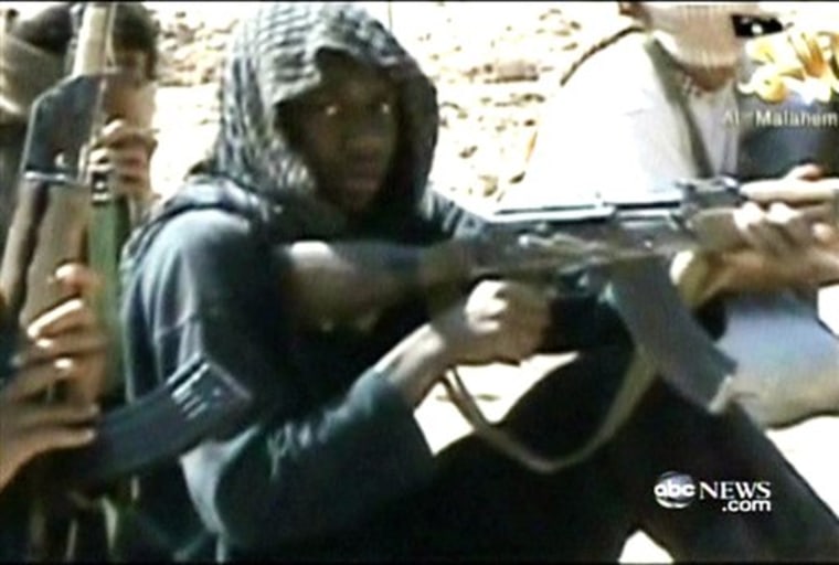 In this video still provided by ABC News from a video produced by al-Qaida, accused underwear bomber Umar Farouk Abdulmutallab and others in his training class fire weapons at a desert camp in Yemen. 